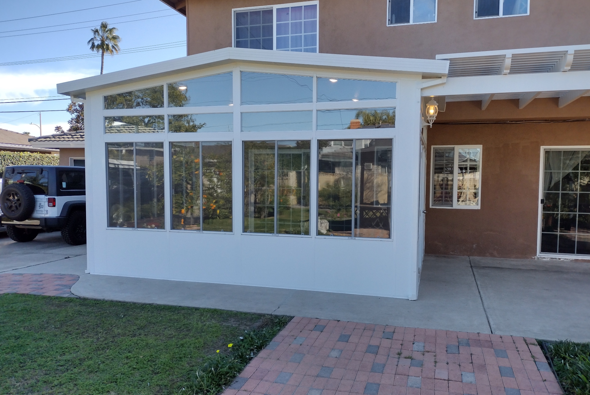 Bright California room sunroom interior with vaulted glass ceiling
